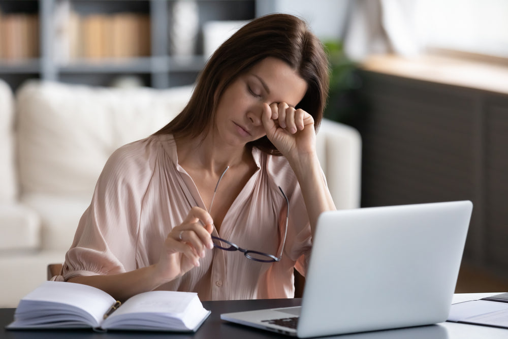 tired woman at desk 